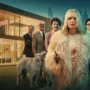 Aniela in a blood-stained fur coat holding a bottle, standing between two contrasting worlds – luxury mansion and gritty housing block – in a promotional image for the Netflix series Aniela.