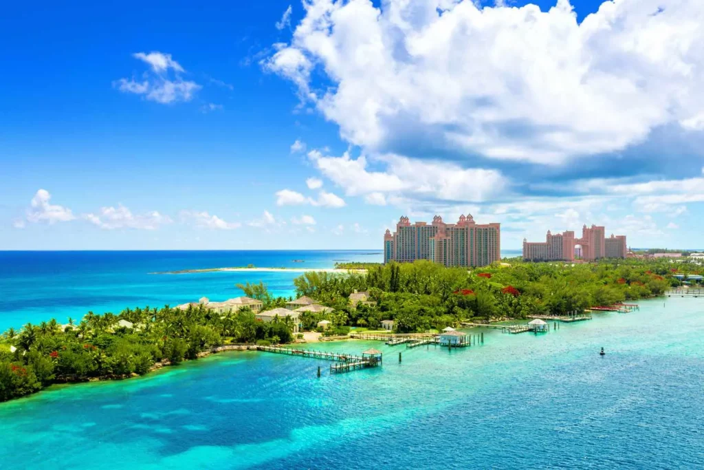 Aerial view of Atlantis Paradise Island resort surrounded by turquoise waters and lush greenery in the Bahamas under a bright blue sky