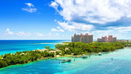 Aerial view of Atlantis Paradise Island resort surrounded by turquoise waters and lush greenery in the Bahamas under a bright blue sky