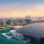 A spectacular sunset over Louvre Abu Dhabi and the skyline of Saadiyat Island, blending art, nature, and modernity.