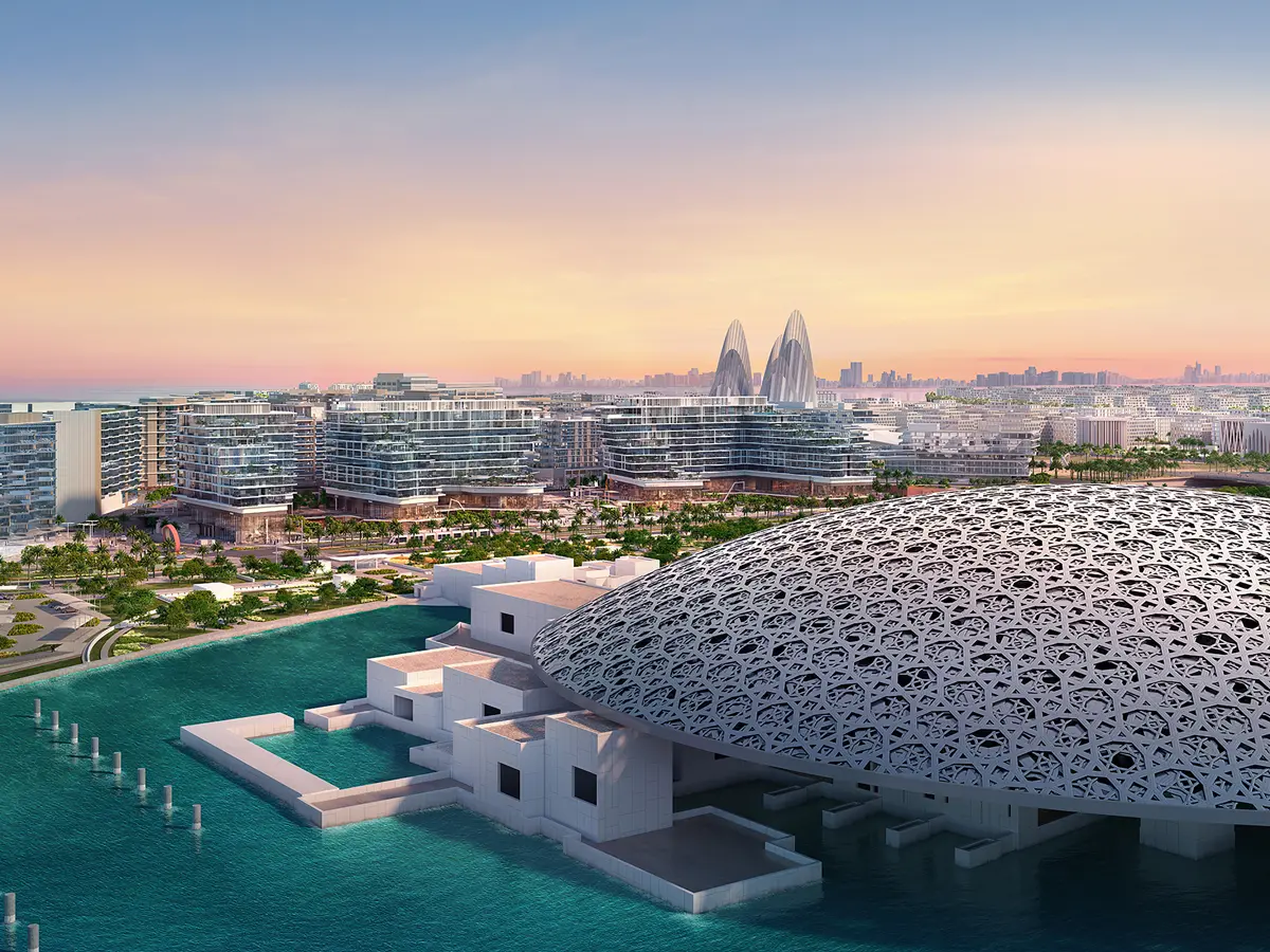 A spectacular sunset over Louvre Abu Dhabi and the skyline of Saadiyat Island, blending art, nature, and modernity.