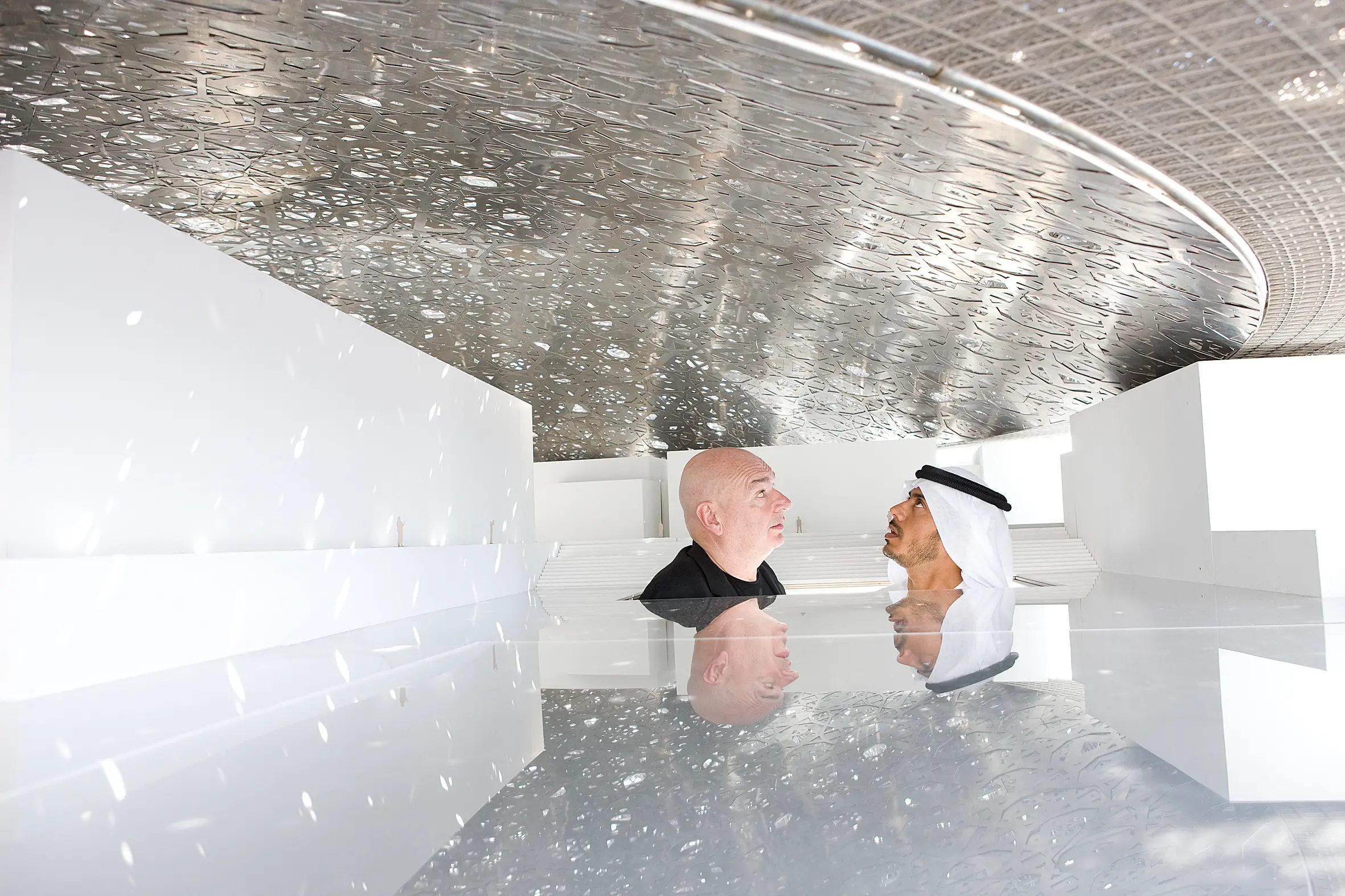 Light plays on the surfaces as visitors admire the complexity of Louvre Abu Dhabi’s iconic dome.