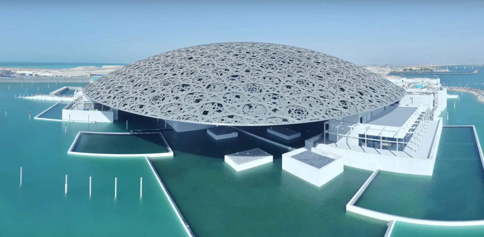 The dome of Louvre Abu Dhabi rises like an island on water, symbolizing a universal connection through art.