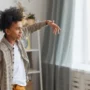 A young boy recording a TikTok dance video at home using a smartphone and ring light, highlighting children’s active use of social media platforms.