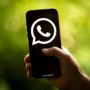 Hand holding a smartphone with large WhatsApp logo on screen, symbolizing blocked VoIP calls and the need for VPN access in countries like Egypt.