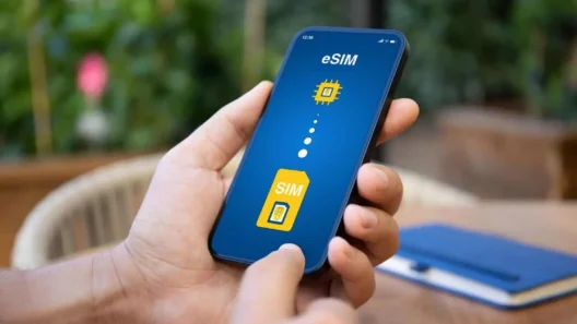 Person holding a smartphone displaying an eSIM activation screen, showing the transition from a physical SIM card to a digital eSIM profile.