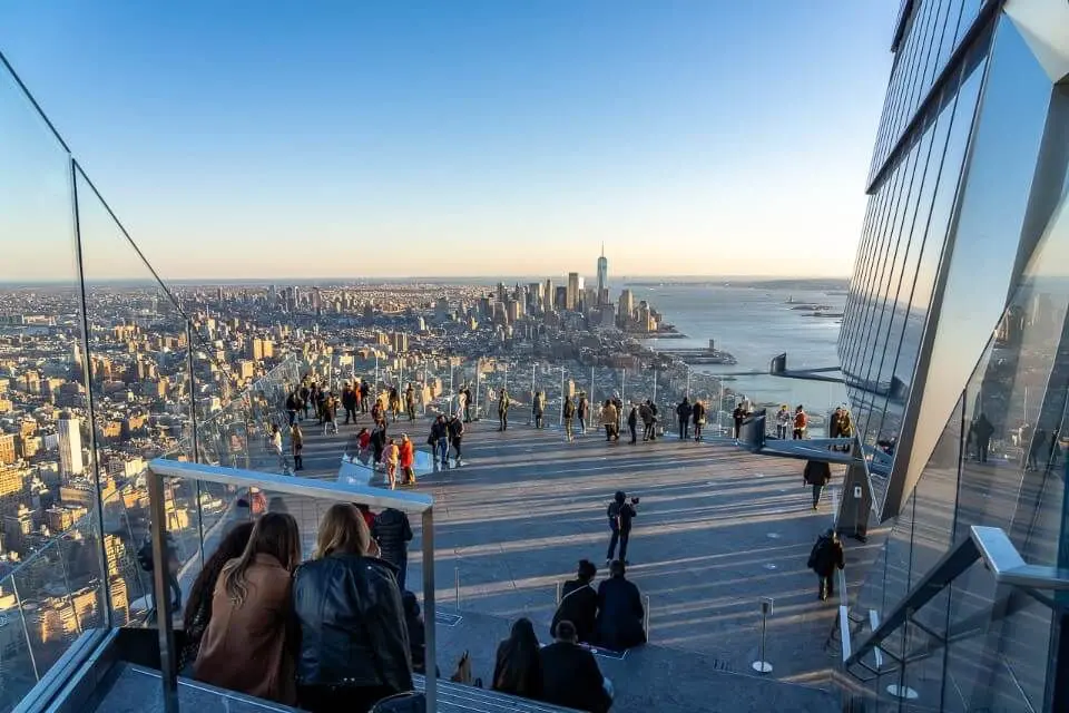 Visitors enjoying panoramic views of Manhattan from Edge Observation Deck at Hudson Yards, New York City.