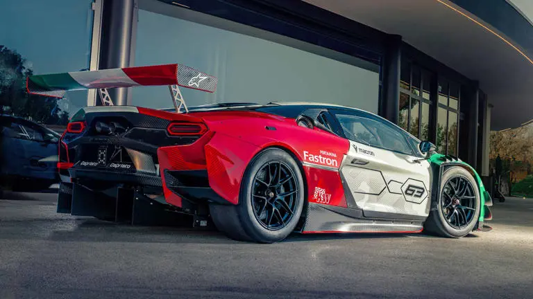 Rear-side detail of Lamborghini Temerario GT3 parked in front of a glass facade, highlighting carbon fiber elements and race-bred styling.