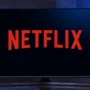 A television screen displaying the Netflix logo on a dark background, symbolizing online streaming and watching movies or shows via Netflix.