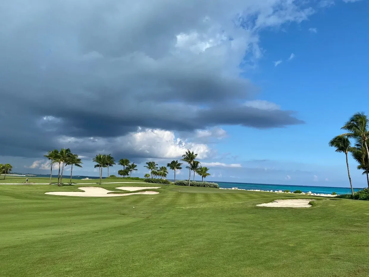 Clouds over bunkered hole with ocean view at Ocean Club Golf Course
