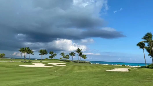 Clouds over bunkered hole with ocean view at Ocean Club Golf Course