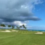 Clouds over bunkered hole with ocean view at Ocean Club Golf Course