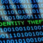 Binary code with the words "IDENTITY THEFT" highlighted, symbolizing digital data breaches and online identity theft. A shadowy human figure in the background represents cybercrime threats.