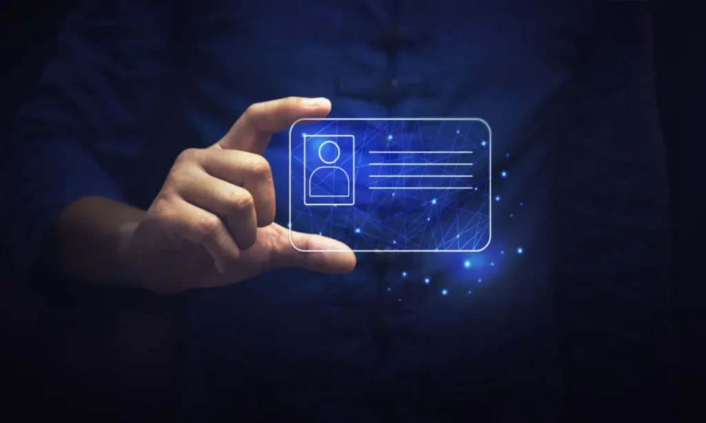 A person holding a glowing digital ID card, symbolizing personal data protection and the importance of safeguarding identity in the digital age.