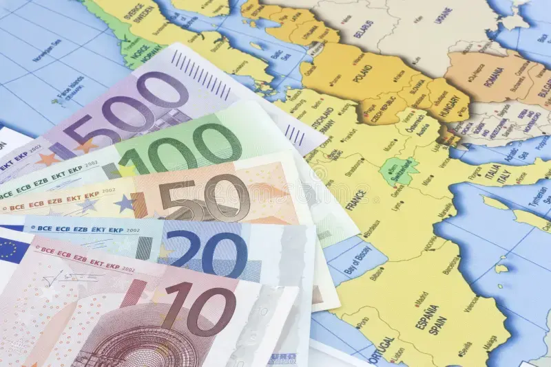 Euro banknotes on a map of Europe – illustrating salary differences and employment costs across European countries.