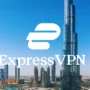ExpressVPN logo centered over the Dubai skyline with Burj Khalifa, illustrating real-world VPN use for streaming, secure browsing, and VoIP calls during travel in the United Arab Emirates.