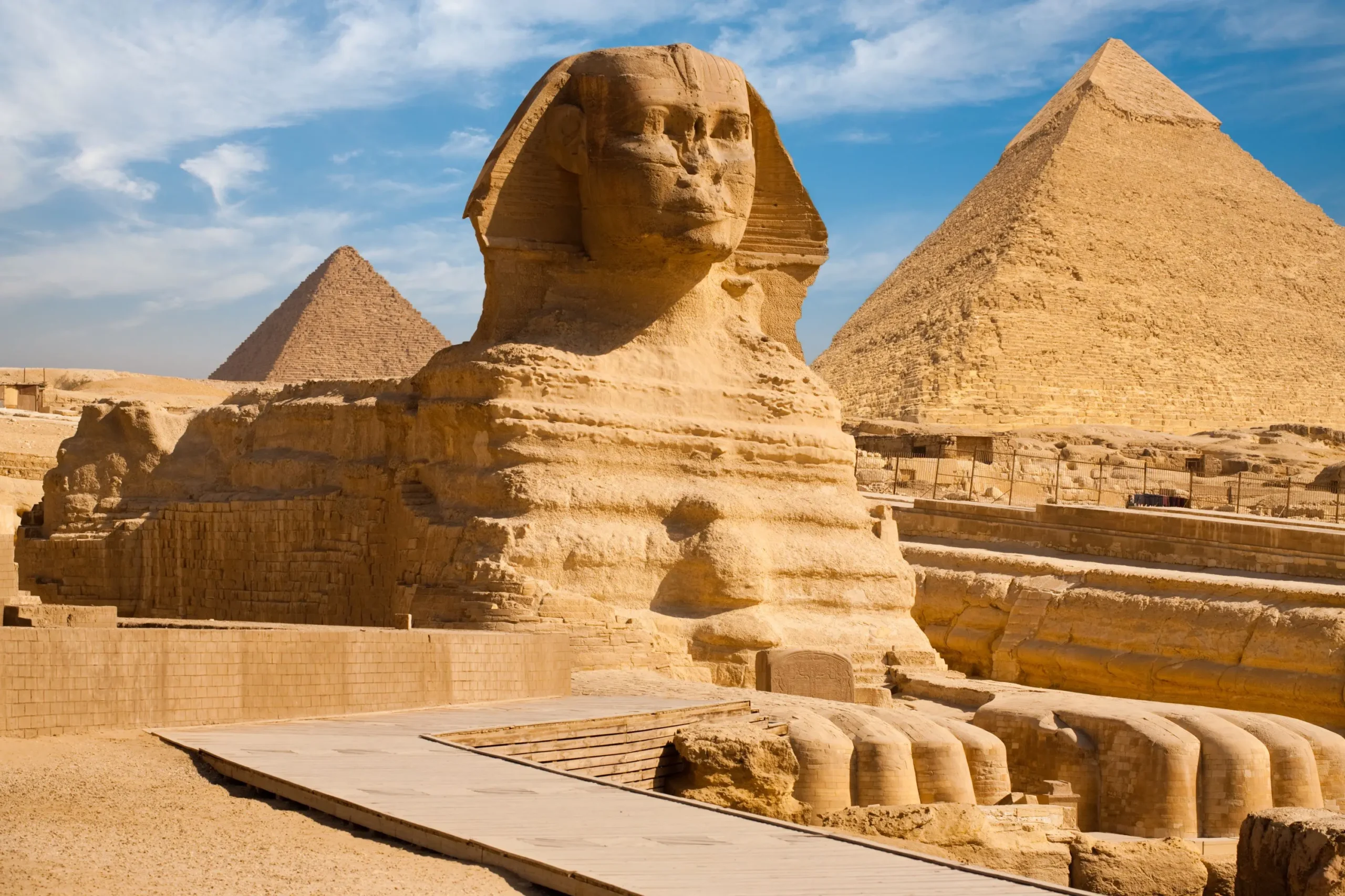 The Great Sphinx of Giza with the iconic pyramids in the background, highlighting the majestic monuments and timeless atmosphere of ancient Egypt.