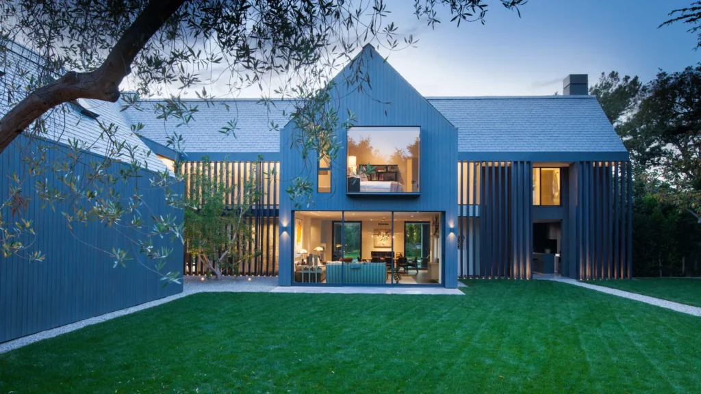 Modern home with large windows and a spacious green yard, illustrating the importance of keeping your home address private and off the internet to protect personal privacy and security.