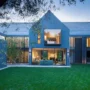 Modern home with large windows and a spacious green yard, illustrating the importance of keeping your home address private and off the internet to protect personal privacy and security.