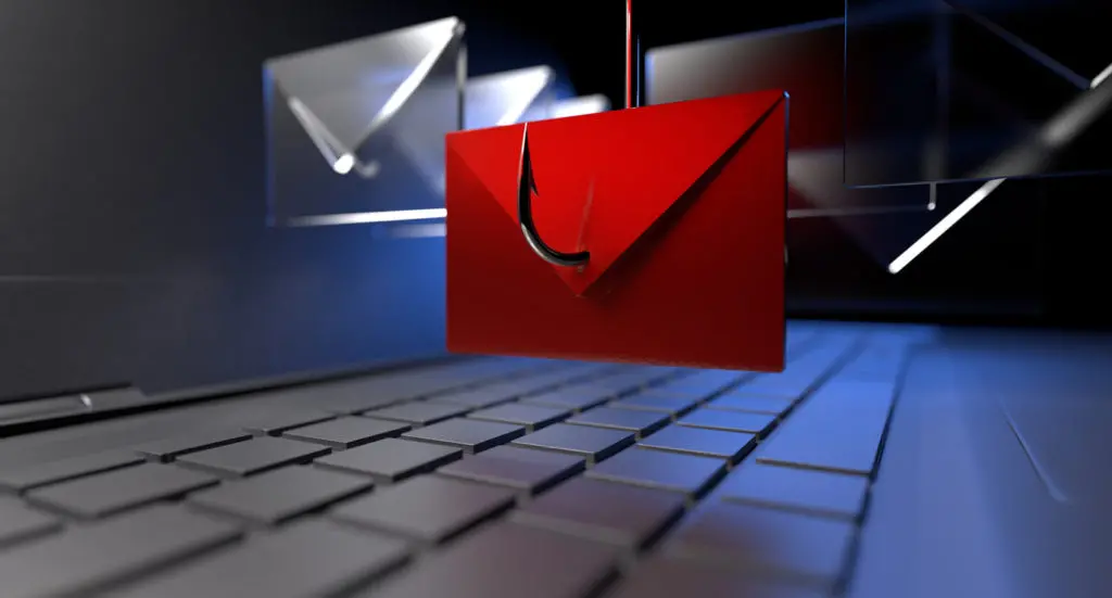 A red envelope with a phishing hook symbol hovers above a laptop keyboard, representing a phishing email attack and the risks of online scams.