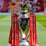 Premier League trophy on the pitch, symbolizing the ultimate prize and historic records every club and player dreams of winning.