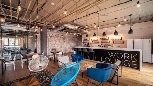 Modern coworking lounge in Prague, featuring stylish seating, a large bar, and bright open space—ideal for digital nomads seeking fast Wi-Fi, networking, and a comfortable remote work vibe.