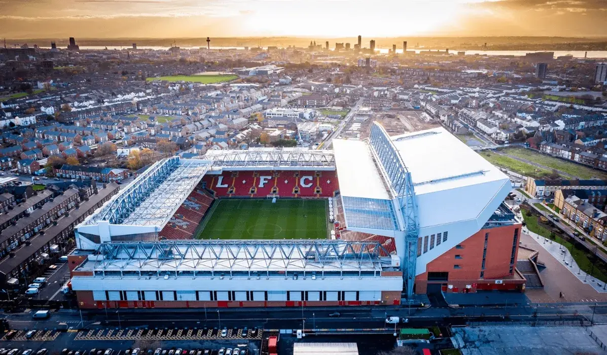Aerial view of Anfield Stadium in Liverpool at sunset, showcasing the legendary home of Liverpool FC surrounded by the city – a must-visit destination for every football fan.