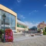 Pilsner Urquell Visitor Centre exterior with brewery buildings, red brick chimneys, and clear blue sky in Pilsen, Czech Republic