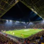 Borussia Dortmund’s Signal Iduna Park packed with fans during a Champions League night, showcasing the electrifying atmosphere of the famous Yellow Wall.