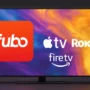 A modern QLED TV screen showing the Fubo logo alongside Apple TV, Roku, and Fire TV logos — reflecting how to stream Fubo on all major devices. Clean layout, no text clutter.