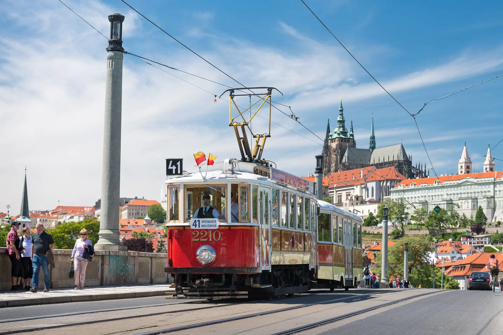 The famous historic Tram 41 crossing Prague with the iconic Prague Castle in the background.