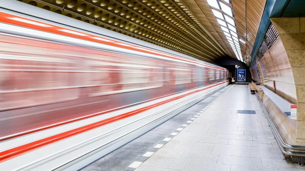Fast-moving Prague metro train at an underground station, capturing the speed and efficiency of public transport.