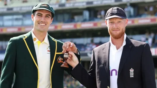 Australia’s Pat Cummins and England’s Ben Stokes holding The Ashes urn trophy ahead of the historic 2025 test cricket series.