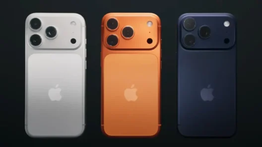 Three Apple iPhone 17 models in silver, orange, and dark blue colors, showcasing the redesigned camera layout and minimalist rear design.