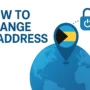 illustration of a blue globe with a large Bahamas flag pin and a padlock icon, featuring the text “How to change IP address” in bold blue letters