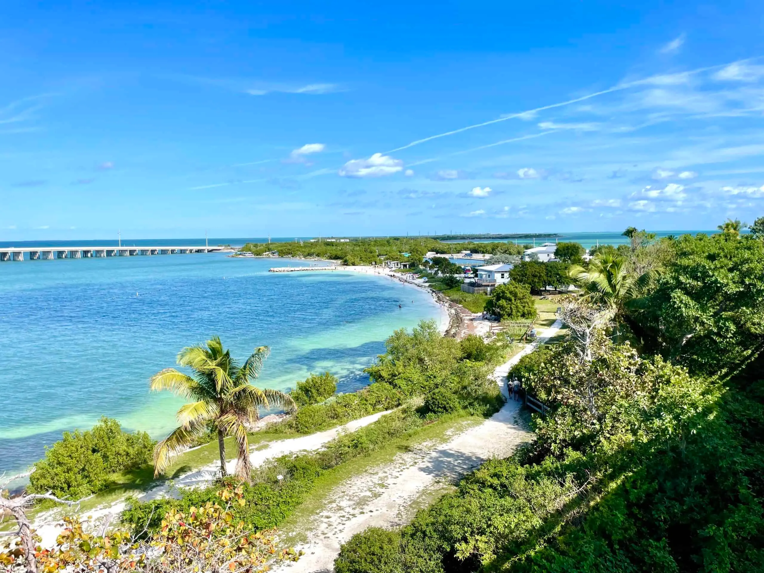 View of Bahia Honda State Park’s turquoise shoreline and iconic old rail bridge under a perfect blue sky in the Florida Keys.