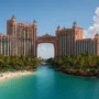 Scenic view of Atlantis Paradise Island resort in the Bahamas with turquoise ocean, palm trees, and the iconic pink towers shining under the tropical sun.