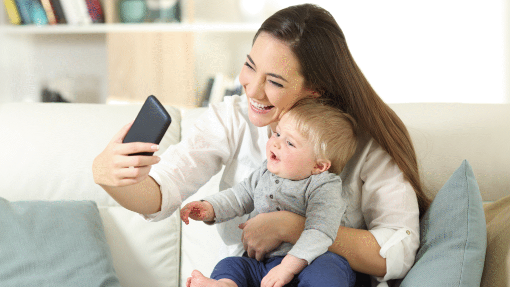 Mom taking a selfie with her baby, both smiling - picture-perfect moment that usually ends up online.