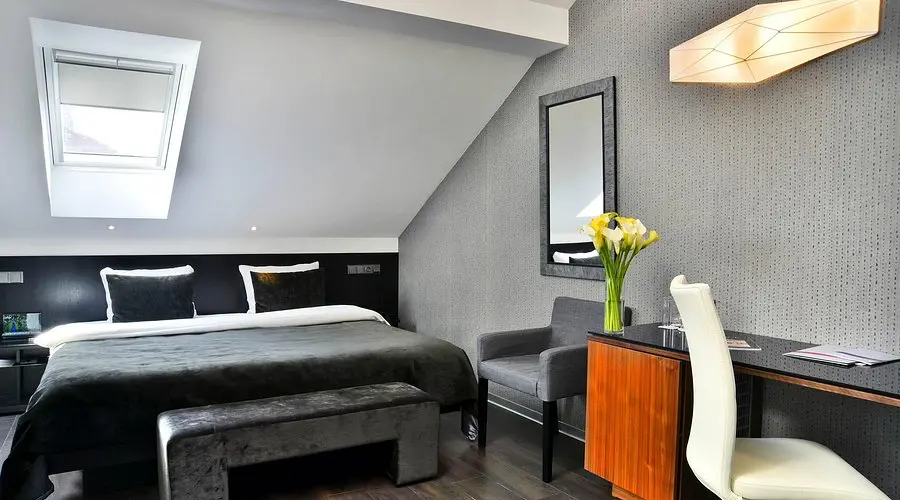 Ametyst Hotel Praha room | Venclikovi.com Elegant modern bedroom at Ametyst Hotel Praha with skylight and minimalist design.