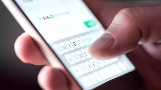 Close-up of a person typing a private message on a smartphone touchscreen — concept of chat surveillance and message scanning under new EU Chat Control law.