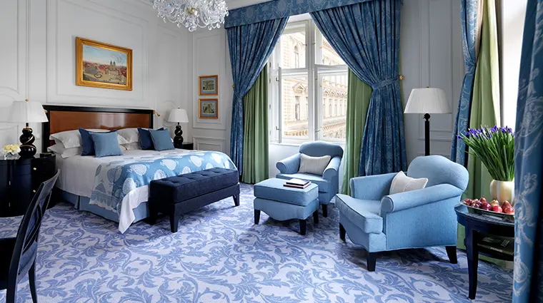 FOUR SEASONS HOTEL PRAGUE 2 | Venclikovi.com Elegant suite at Four Seasons Hotel Prague with classic blue décor, city view, and luxury furnishings.