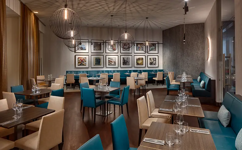 Hermitage Hotel Prague 2 | Venclikovi.com Elegant restaurant interior at Hermitage Hotel Prague with teal chairs and modern lighting