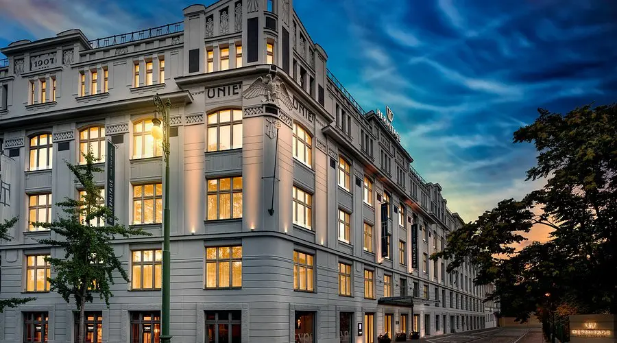 Hermitage Hotel Prague | Venclikovi.com Exterior view of Hermitage Hotel Prague with Art Nouveau architecture at sunset.