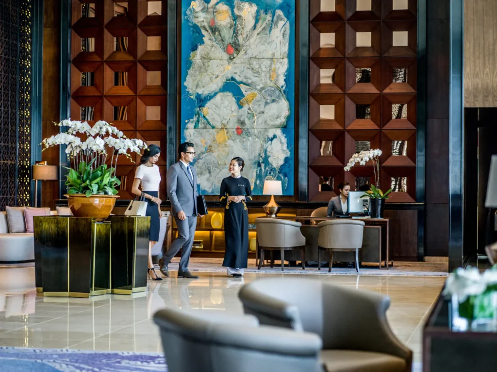 InterContinental Hanoi Landmark72 Vietnam 2 | Venclikovi.com InterContinental Hanoi Landmark72 lobby with modern art, wood panel walls, and staff welcoming guests.
