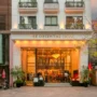 The Oriental Jade Hotel exterior in Hanoi with warm lighting and street view at sunset.