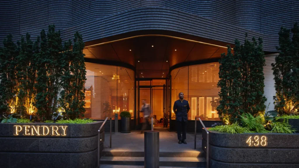 Pendry Manhattan West Luxury hotel NYC | Venclikovi.com Elegant entrance of Pendry Manhattan West hotel at night with glowing lights and doorman by the door