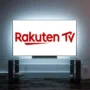 Rakuten TV logo displayed on a large Smart TV in a dark room