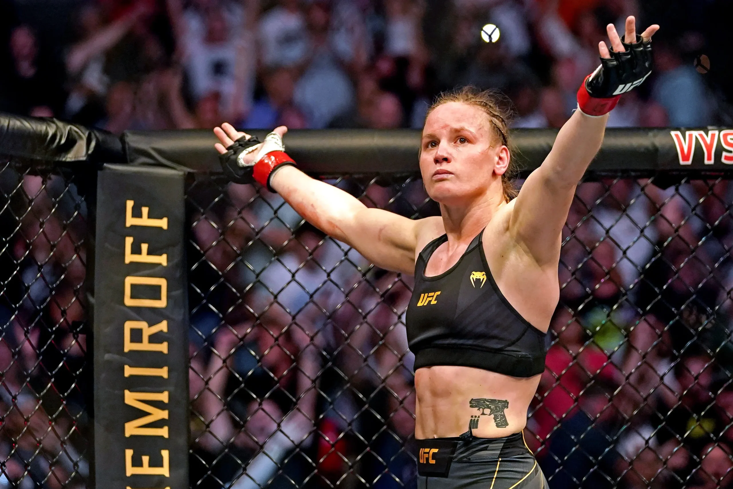Valentina Shevchenko-2 | Venclikovi.com Valentina Shevchenko standing confidently in the Octagon after her UFC fight, arms raised in front of the crowd