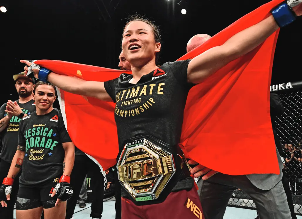 Zhang Weili | Venclikovi.com Zhang Weili holding the Chinese flag and UFC title after a big win inside the Octagon