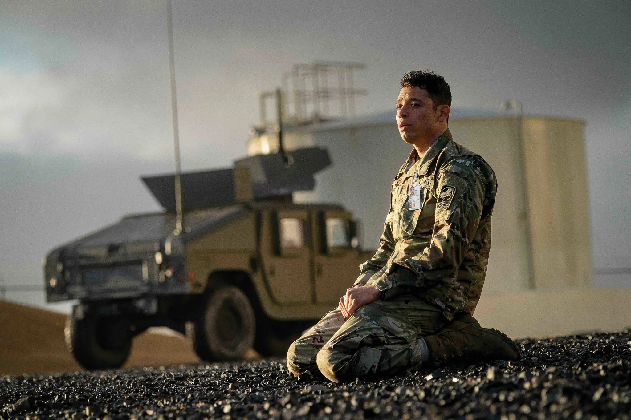 a-house-of-dynamite-2025-military-scene-actor-ramirez | Venclikovi.com Military officer kneeling on base in A House of Dynamite